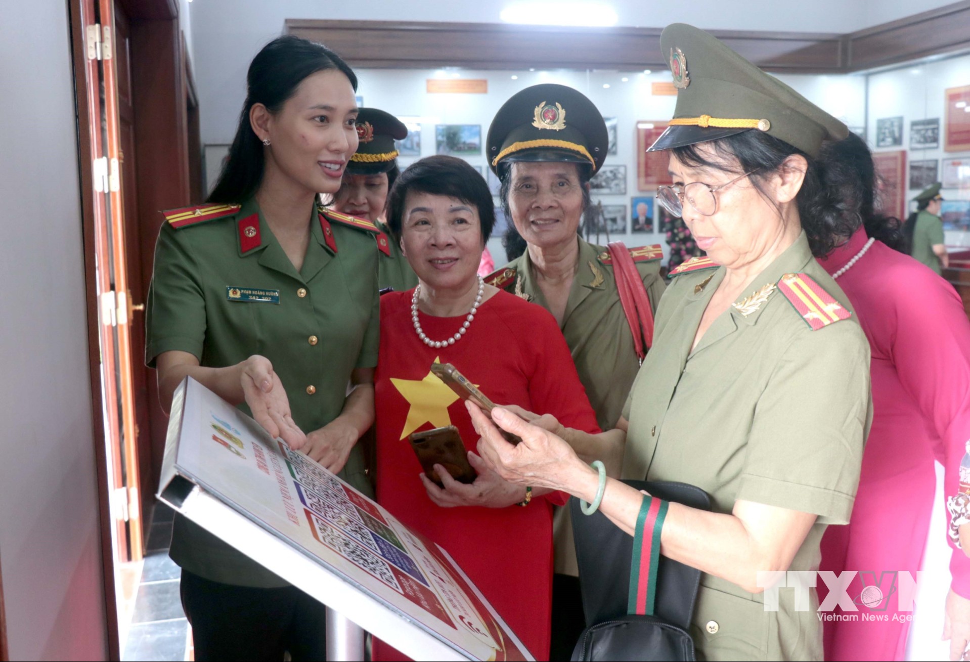 Cán bộ Công an tỉnh Hưng Yên giới thiệu, hướng dẫn các đại biểu trải nghiệm tra cứu thông tin số hóa qua mã QR Code tại Khu lưu niệm Anh hùng liệt sĩ Công an nhân dân Bùi Thị Cúc tại xã Xuân Trúc. (Ảnh: Đinh Văn Nhiều/TTXVN)